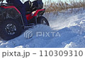 The ATV rides in slow motion through the snow 110309310