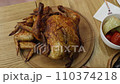 Baked chicken with wings on a wooden tray 110374218