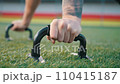 Young man exercising outdoors, does push-ups on the push-up platform at stadium 110415187