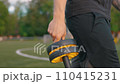 Guy walking around the stadium with abdominal rollerr in his hands abdominal roller 110415231