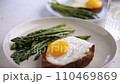 Fried eggs with toasted bread and green asparagus. Fast lunch ideas, healthy breakfast, summer food. 110469869