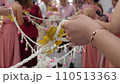 bridal friends holding flower line as barrior to ge bridal in Thailand cwedding ceremony 110513363