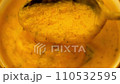 Pumpkin soup puree stirred with a spoon 110532595