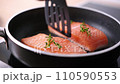 Pan-fried Salmon. Cooking salmon in a pan. 110590553