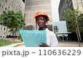 Professional female engineer in hardhat reading documents 110636229