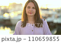 Portrait of a young girl against the backdrop of a sea pier with yachts and boats 110659855
