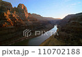 flying through picturesque famous grand canyon of Colorado river with red sandstone rocks in light of sunset, Arizona 110702188