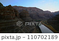 Flying toward red sandstone rocks in famous grand canyon of Colorado river, river turns right, blue hour 110702189