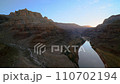 the last rays of sunset illuminate the limestone rocks of Grand Canyon, flying over Colorado River, Arizona 110702194