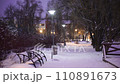 public garden on Sovetskaya emb in Pskov. Winter evening, snowfall, benches  110891673