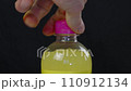 The process of opening a bottle of lemonade on a black background, macro video 110912134