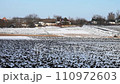 Natural winter background. Snow-covered Houses and vegetable gardens in the village. 110972603