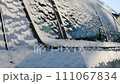 A grey car in the snow. Close up 111067834