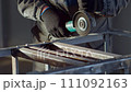 Mechanic works with angle grinder and cleans metal from old paint. Slow-motion close-up video 111092163