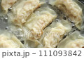 Top view of cooking fried japanese dumplings or gyoza in Boiling Water. 111093842