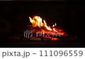 close-up zooming in fire burns firewood in fireplace 111096559