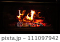 fire in fireplace burns firewood with zooming in 111097942