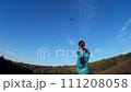 Young girl steering bird-like kite in nature 4 111208058