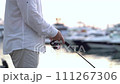 fisherman catches fish from the shore near the boat station. 111267306