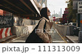 Confident attractive female casually walks around the neighborhood with the famous Brooklyn Bridge in the back 111313009