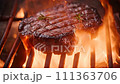 Ribeye Steak on Grill with Fire close-up 111363706