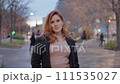 frontal posed of a beautiful woman with black coat and light brown dress 111535027