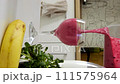 Closeup view of pouring berry and banana smoothie in a wine glass  111575964