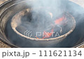 Swirling Smoke Above Flames on Charcoal Grill. 111621134