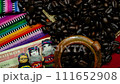 Coffee beans in burlap with mayan worry dolls and money on colorful indigenious handmade textiles.. Concept for international coffee culture and business. Slow motion macro dolly tracking shot 111652908