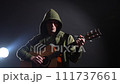 Musician playing acoustic guitar on black background 111737661