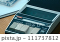 Police interview audio cassette tape playback on vintage player with handcuffs on table 111737812