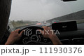 Driver view on highway with windshield wipers during rain 111930376