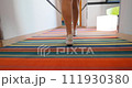 Person legs walking on vibrant striped carpet - steadicam following shot 111930380