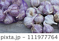 Garlic on wooden vintage background. Seedlings for planting garlic. 111977764