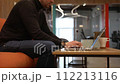 A programmer coding at lap top at coworking space 112213116