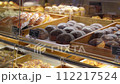 Assorted pastry and bread arranged on tray selling at bakery shop. 112217524