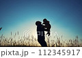 father throws play baby in the park. father's day silhouette happy family child dream concept. father plays with baby throws up. dad play his son in nature in the lifestyle park silhouette at sunset 112345917