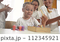 child group playing fishing lifestyle. children in kindergarten play with toys. happy family kid dream concept. a group of children collect building blocks in a kindergarten indoors 112345921
