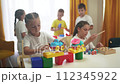 child group playing fishing. children in kindergarten play with toys. happy family kid lifestyle dream concept. a group of children collect building blocks in a kindergarten indoors 112345922