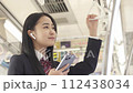 A female student with a smartphone and earphones on the train 112438034
