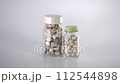 A bottle containing two tablets lined up ③ 112544898