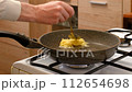 Unrecognizable man frying potato pancakes in a frying pan 112654698