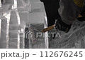 Closeup of ice sculptor hands cutting shaping 112676245