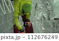 Ice sculptor shaping ice figure 112676249