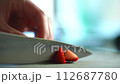 Hand cutting strawberries Japanese woman 4K slow motion 112687780