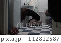 Eating disorder concept. Side view of a young woman vomiting in toilet sitting on the floor in black dress. Realistic cinematic dolly in shot in indoor bathroom. High quality 4k footage 112812587