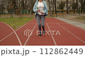 Active healthy sporty lifestyle. Senior woman doing sports at stadium. 112862449