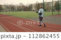 Mature adult woman practicing fitness outdoors holding yoga mat. Sports for elderly people. 112862455