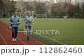 Couple old men running marathon stadium arena. Grandparent jog together. Romantic elderly smiling people sport training. Granny and Grandpa workout. Love athletes. Active senior lifestyle. Health care 112862460