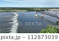 Chain of Rocks on the Mississippi River above St Louis with the Low Water Dam, water towers, old historic bridge and the new bridge with construction work 112873039